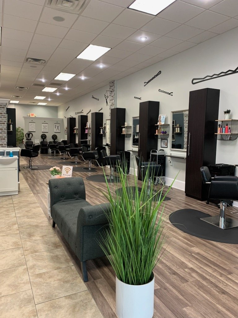 Hair styling station with salon chairs and mirrors.